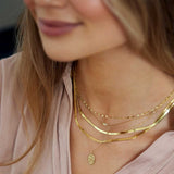 14k yellow gold keyhole chain layered style shown on model
