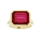 Lab-created ruby cocktail ring with 12x10mm stone in horizontal east-west bezel setting