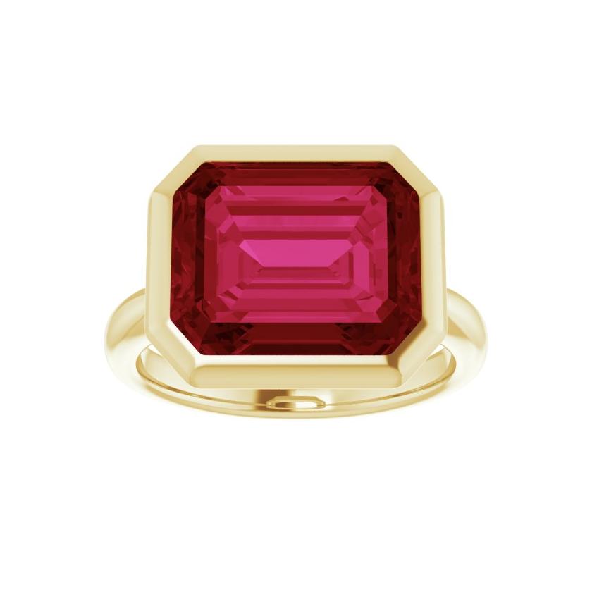 Lab-created ruby cocktail ring with 12x10mm stone in horizontal east-west bezel setting