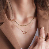 Cancer zodiac diamond necklace layered on neck