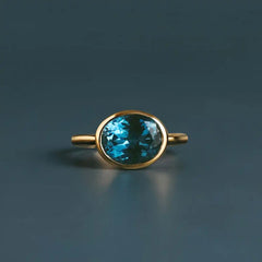 East-west London blue topaz cocktail ring in 10K yellow gold, oval stone set horizontally