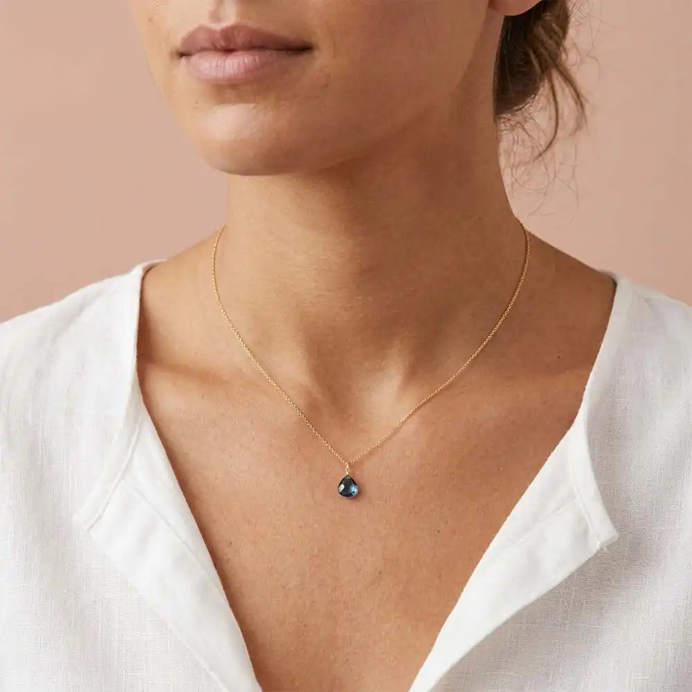 Timeless London blue topaz pendant necklace with understated elegance on model