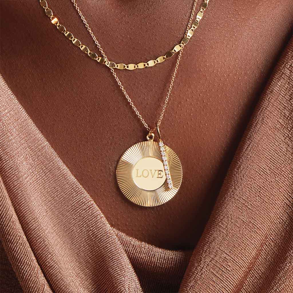 Mirror chain necklace on model, showing reflective shimmer