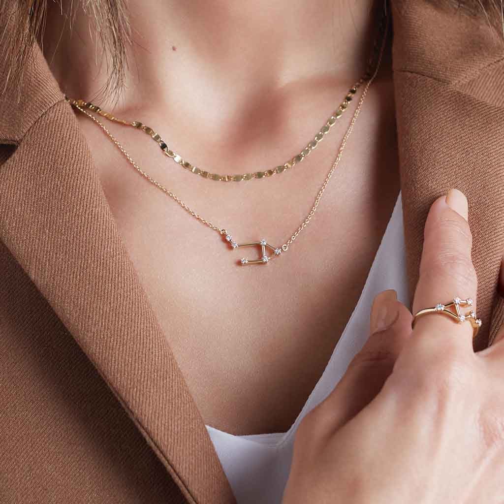 Mirror chain layered with other necklaces on model