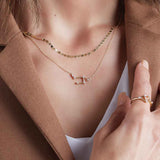 Mirror chain layered with other necklaces on model