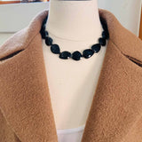 Onyx beaded necklace on model, bold black stone strand with silver accents variant--Onyx
