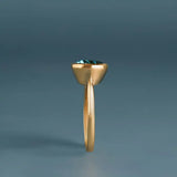 London blue topaz ring side view showing east-west oval stone depth in yellow gold
