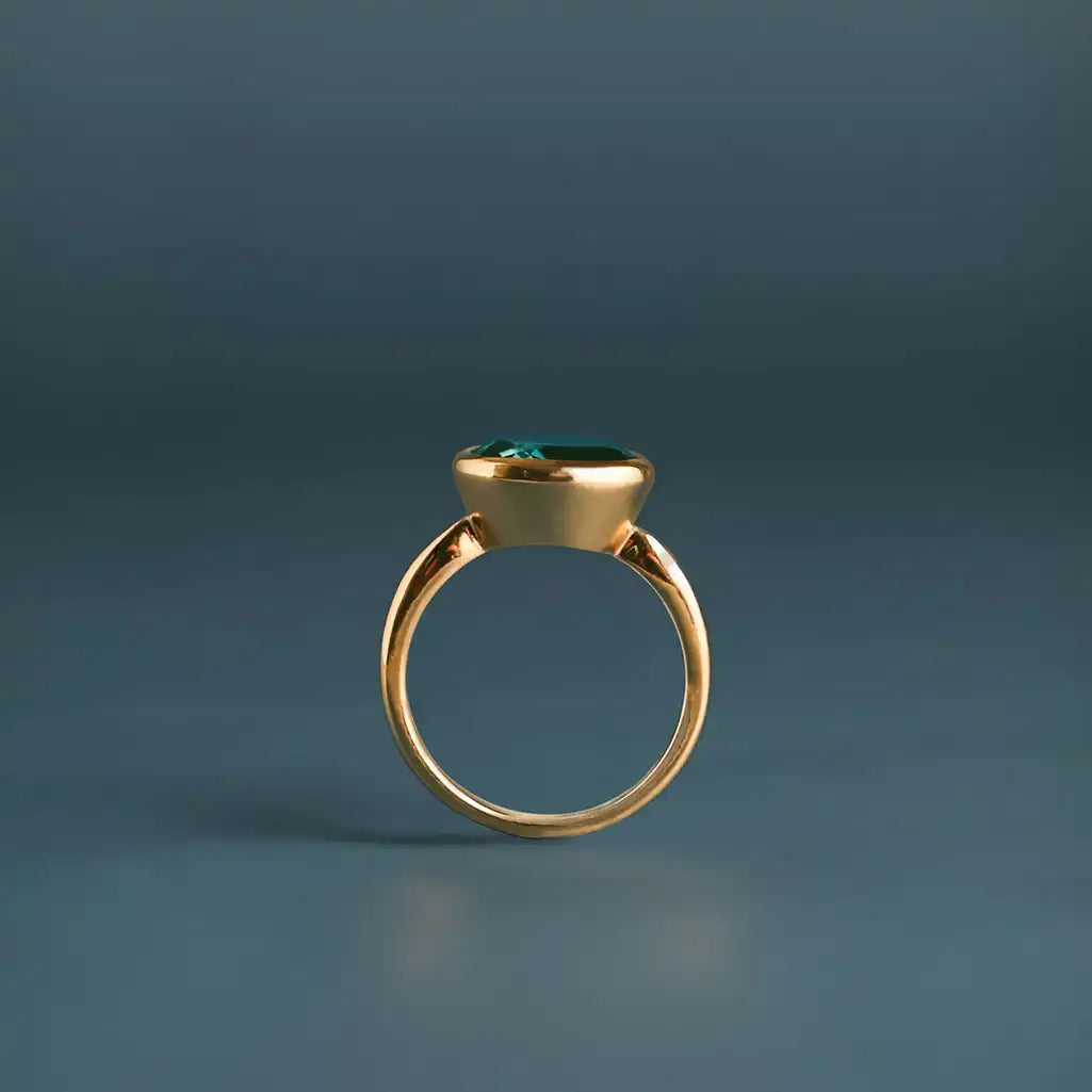 Oval London blue topaz cocktail ring in 10K yellow gold, top-down view