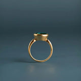Oval London blue topaz cocktail ring in 10K yellow gold, top-down view