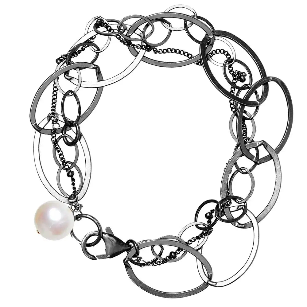 Natural pearl woven chain bracelet in sterling silver, flat lay on neutral background
