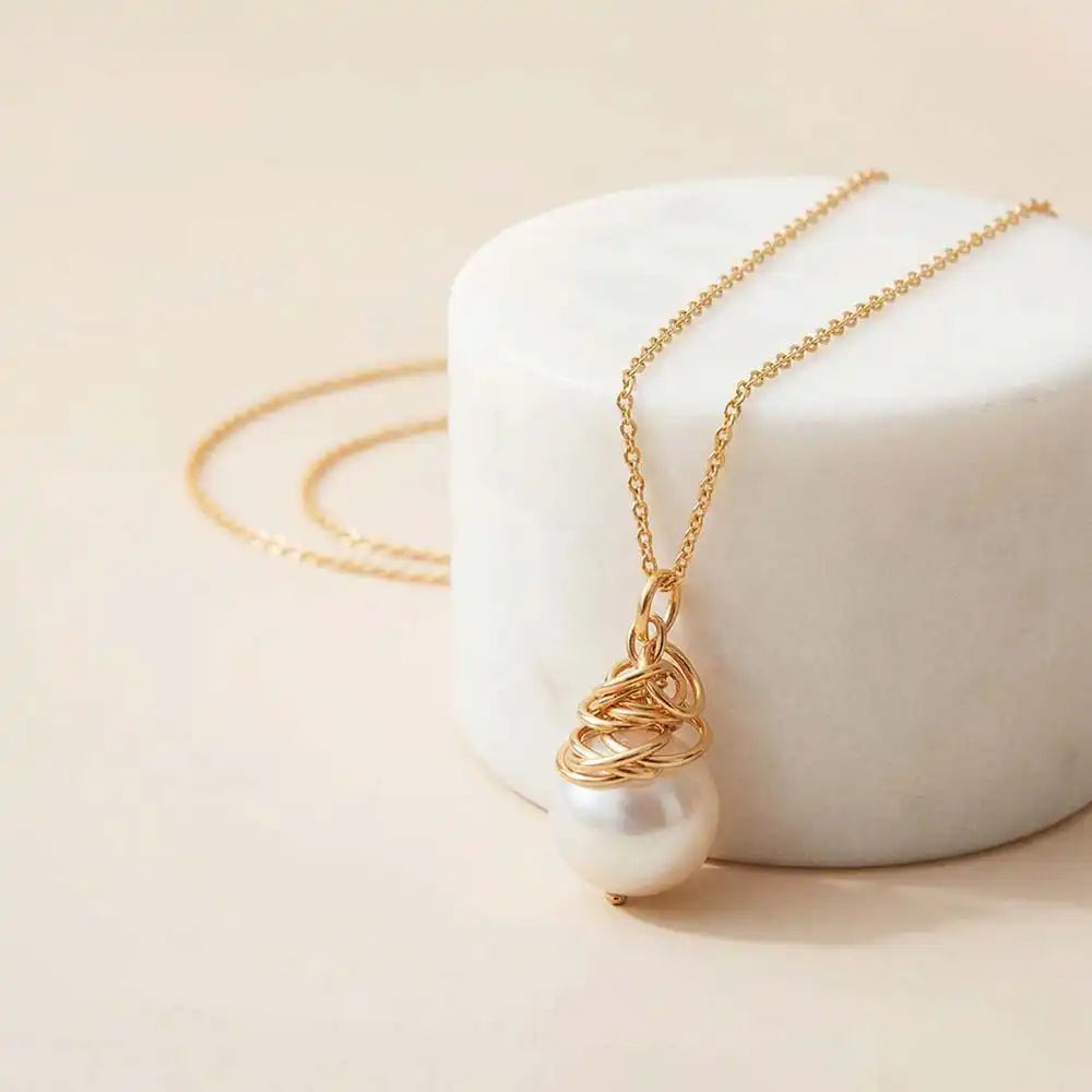 Pearl pendent hanging from a sterling silver chain variant--Gold-fill variant--Sterling-silver variant--Pearl