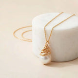 Pearl pendent hanging from a sterling silver chain variant--Gold-fill variant--Sterling-silver variant--Pearl