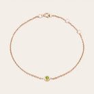 Bezel-set peridot bracelet in 14K rose gold, wrist view on model