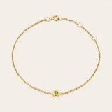 Bezel-set peridot bracelet in yellow gold, close-up of stone setting yellow gold variant--14K-yellow-gold variant--Peridot