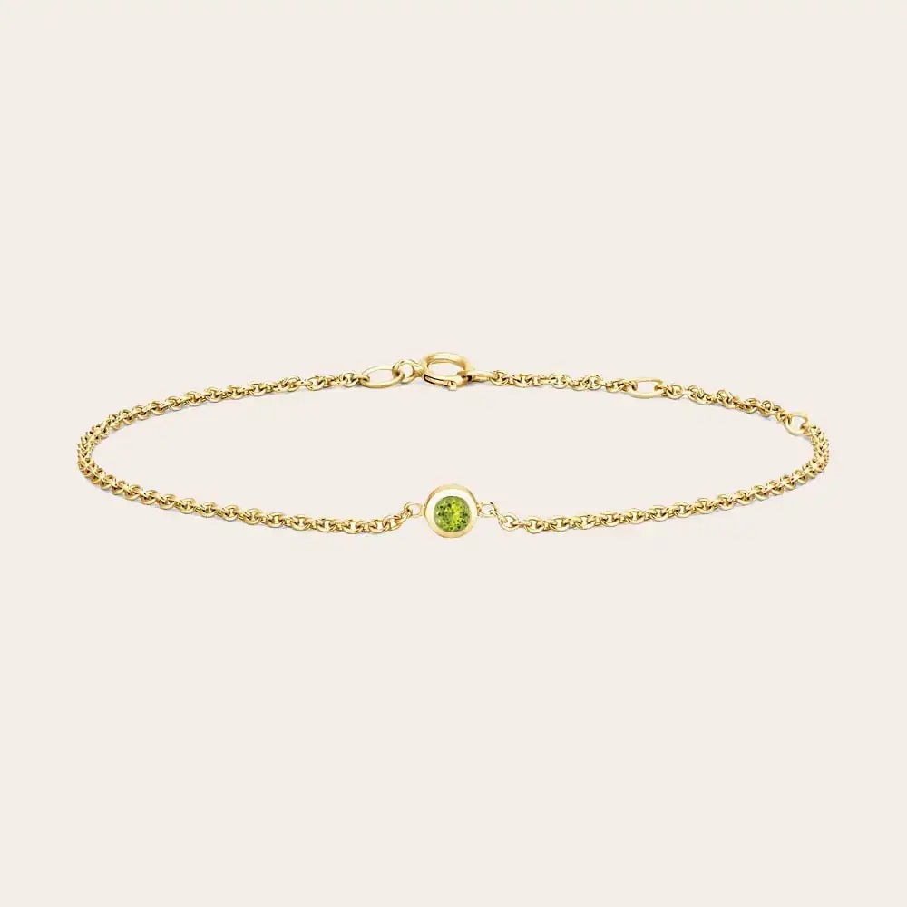 Bezel-set peridot bracelet in sterling silver, close-up of stone setting
