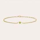 Bezel-set peridot bracelet in sterling silver, close-up of stone setting