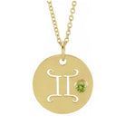 Dainty Gemini zodiac pendant and gemstone charm necklace in polished 14K yellow gold.