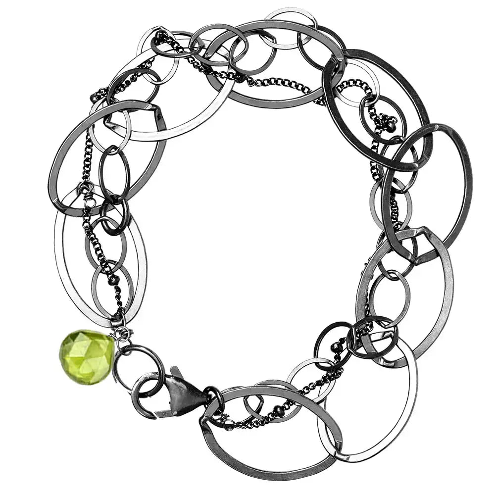 Natural peridot woven chain bracelet in sterling silver, flat lay on neutral background sterling silver variant--Oxidized-sterling-silver