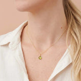 Elegant peridot gemstone necklace with light, airy silhouette on model