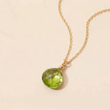 Peridot necklace with bright green gemstone on a delicate chain