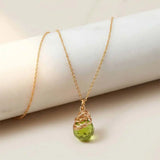 Natural peridot pendant necklace in sterling silver, styled on chain necklace variant--Gold-fill variant--Sterling-silver variant--Peridot