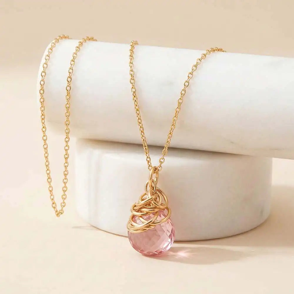 Natural pink topaz pendant necklace in gold-fill editorial shot variant--Gold-fill variant--Rose-Gold-fill variant--Sterling-silver variant--Oxidized-sterling-silver variant--Pink-Topaz
