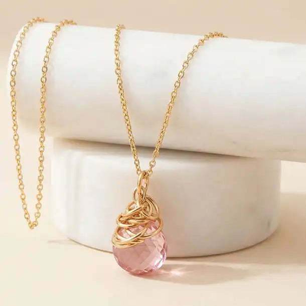 Natural pink topaz pendant necklace in gold-fill editorial shot variant--Gold-fill, variant--Rose-gold-fill, variant--Sterling-silver, variant--Oxidized-sterling-silver variant--Pink-topaz