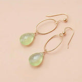 Faceted prehnite drop earrings in yellow gold fill, soft sage-green gemstone teardrop briolette suspended from slim oval gold link, blush background. all-groups