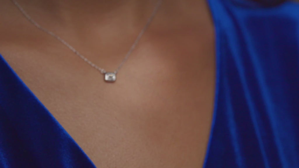 Video of emerald-cut lab-grown diamond necklace in 14K gold, pendant movement on chain