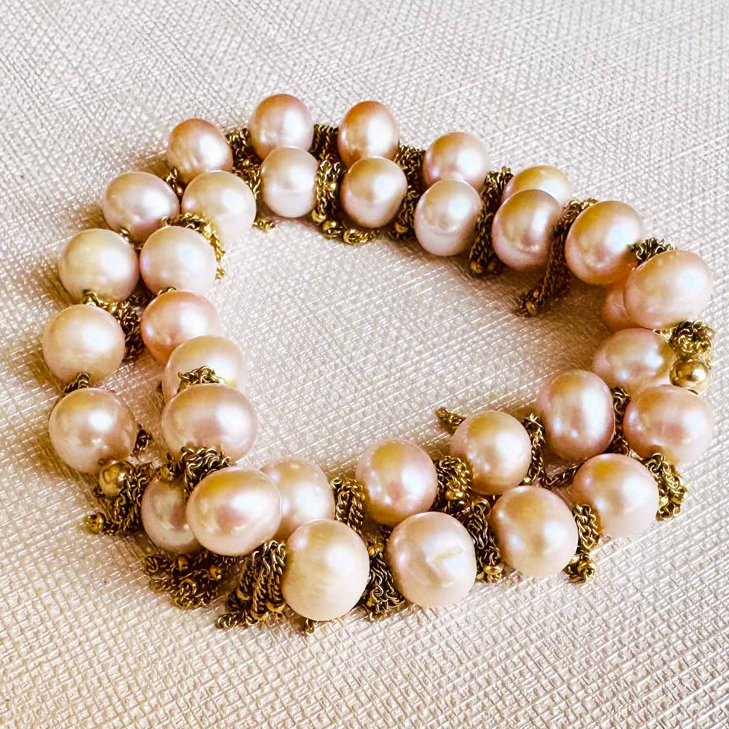 Fringe stretch bracelet with gemstone beads and gold-fill fringe, on wrist showing fringe movement variant--Pearl
