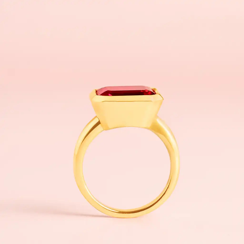 Ruby cocktail ring in yellow gold, side view showing east-west stone orientation