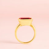 Ruby cocktail ring in yellow gold, side view showing east-west stone orientation