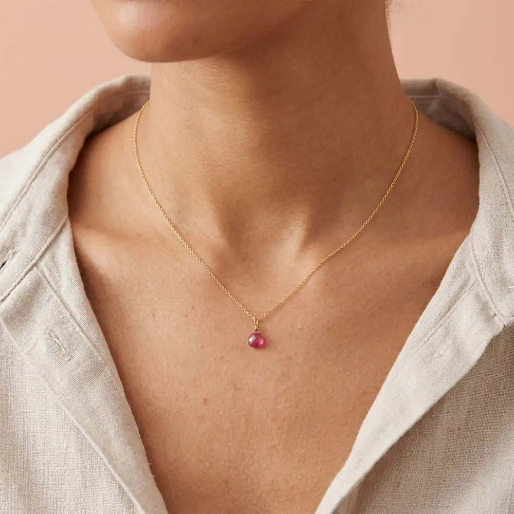 Minimal ruby pendant necklace with deep crimson sparkle on model