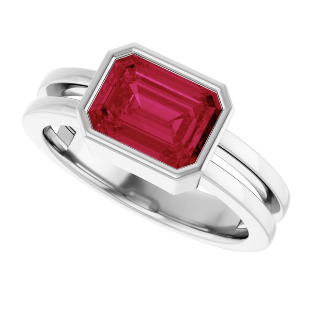Elegant emerald-cut ruby cocktail ring in 14K white gold.
