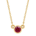 Close-up of 5 mm (~0.65 ct) ruby set in 14K yellow gold on 16" chain.