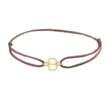 Sans serif initial B silk bracelet in 14K yellow gold on brown silk