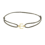 Sans serif initial E silk bracelet in 14K yellow gold on olive silk