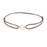 Sans serif initial G silk bracelet in 14K yellow gold on brown silk