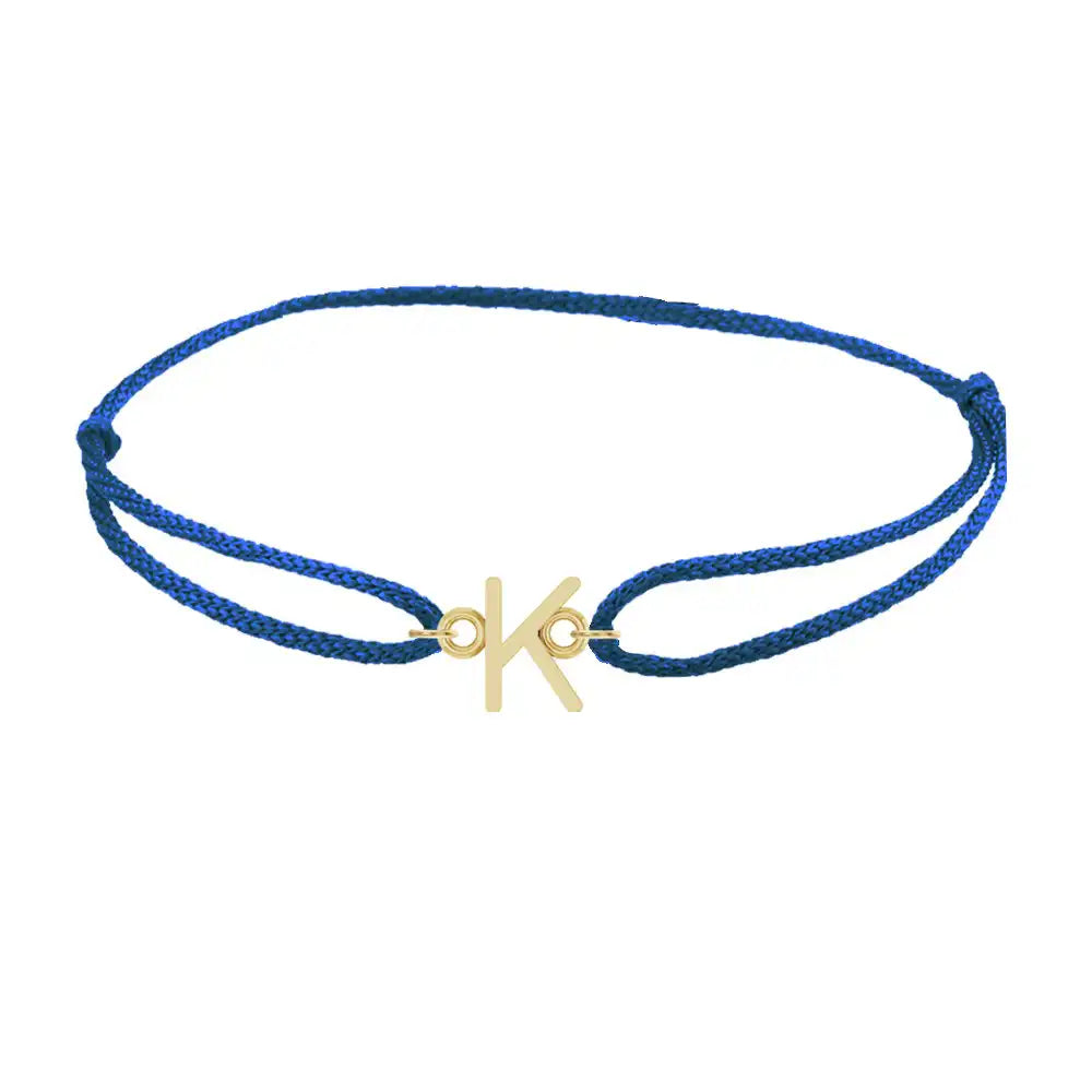 Sans serif initial K silk bracelet in 14K yellow gold on blue silk