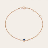 Bezel-set sapphire bracelet in 14K rose gold, close-up of blue stone in bezel rose gold variant--14K-rose-gold variant--Sapphire