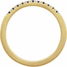 Side view of blue sapphire stacking ring in yellow gold