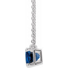 Side view of sapphire necklace and fine cable chain clasp