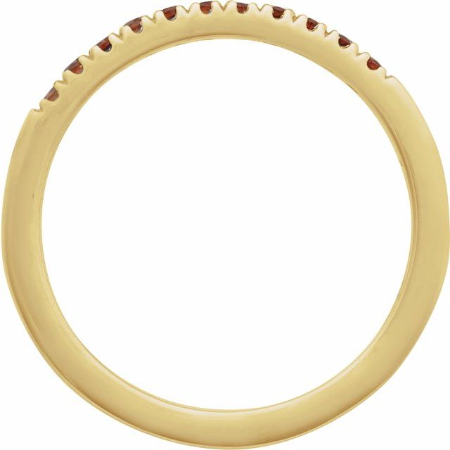 Slim yellow gold band set with eleven deep red garnets side view
