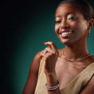 elegant flexible diamond bracelet stacked with white gold bangles on wrist