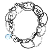 Natural swiss blue topaz woven chain bracelet in sterling silver, flat lay on neutral background sterling silver variant--Swiss-Topaz variant--Oxidized-sterling-silver