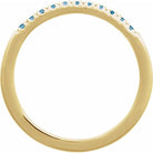 Close-up of Swiss blue topaz stacking ring in 14K yellow gold