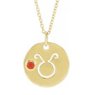 Dainty Taurus zodiac pendant and gemstone charm necklace in polished 14K yellow gold.