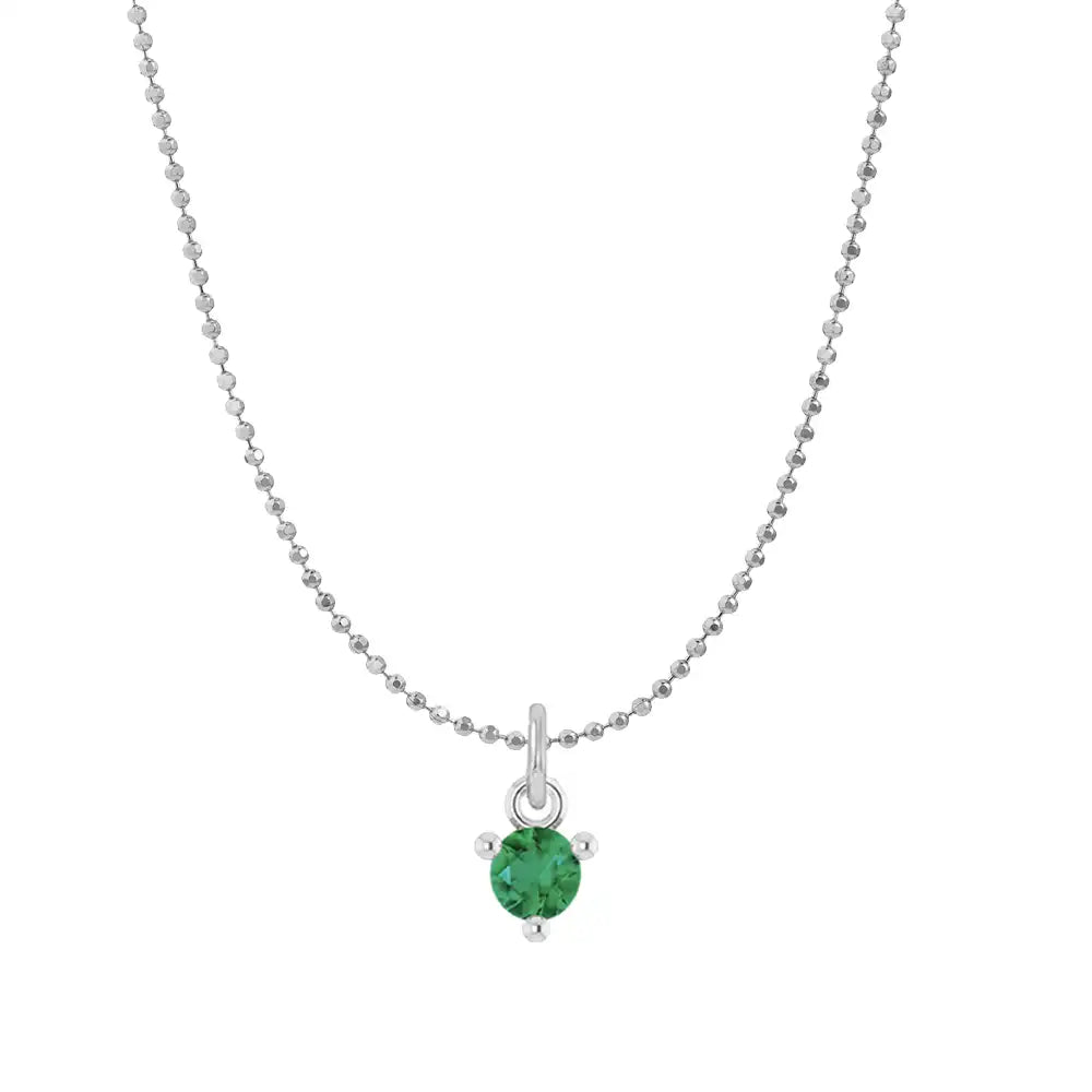 Tiny emerald solitaire necklace in 14K white gold