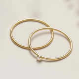 Tiny diamond stackable ring in 14K gold, front view