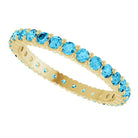 Aquamarine eternity ring in 10K yellow gold, handcrafted using recycled metal.